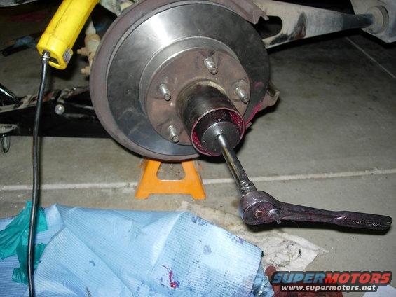 Tightening wheel bearings.  Inner nut installed and tightened first to 50lbs, then backed off & retightened to 40lbs.  Washer  inside tab installed in axel groove, & hole in washer installed on inner nut pin.   Outboard nut tightened to 200lbs.