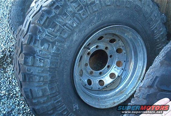 Close-up of an off-road tire with 'INTERCO SUPER SWAMPER' text and a metal rim