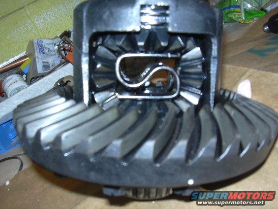Differential gears with a metal C-clip inside, close-up view