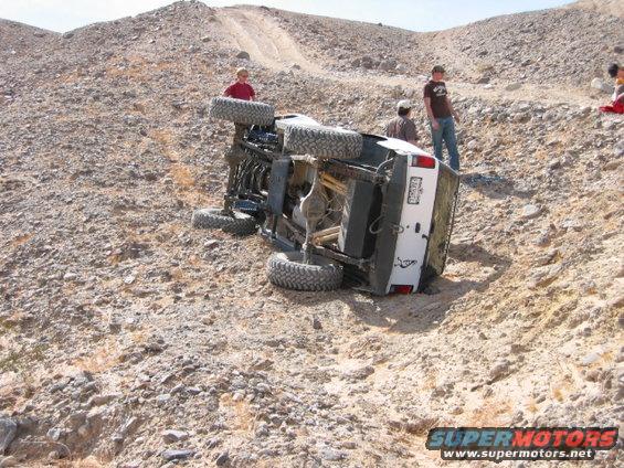 White 1997 Ford Ranger on its side on a rocky hill