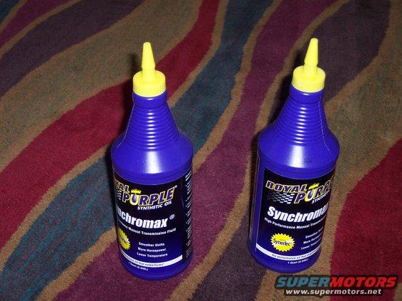 Two bottles of Royal Purple Synchromax synthetic oil with yellow caps, placed on a striped carpet