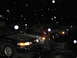 1995 Ford Thunderbird - Three cars are parked outside at night while snow falls.