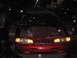1995 Ford Thunderbird - Front view of a red car at night with snow falling.