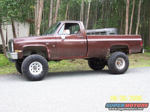 Brown pickup truck with large tires and lifted suspension