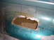 1996 Ford Bronco - A section of a teal vehicle's body panel shows significant rust damage and has been marked for repair.