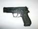 1982 Chevrolet C/K Pickup - A black semi-automatic pistol is shown against a white background.