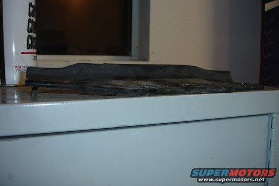 Black rubber trim piece on a shelf
