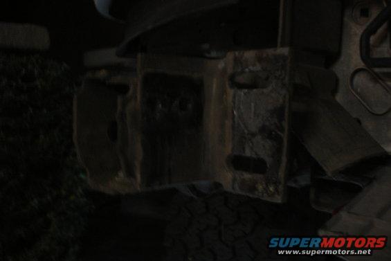rusted metal bracket with rectangular cutouts