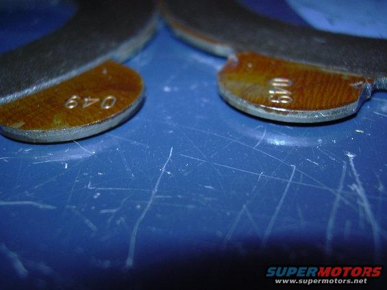 Close-up of two differential gears with numbers 640 and 049 stamped on them