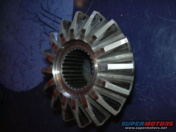 Close-up of a differential gear with many teeth. It has a splined center hole