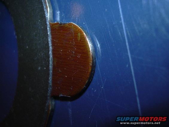 Close-up of a brake pad material on a metal backing plate