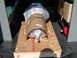 1989 Ford Bronco - A transmission is secured on a pallet for transport, with other items like a gas can and electronics box also present.