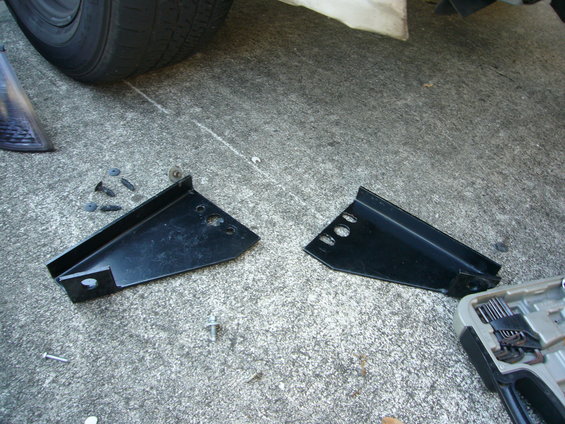 Pair of black Go Rhino push bumper brackets on concrete with tire and tool case