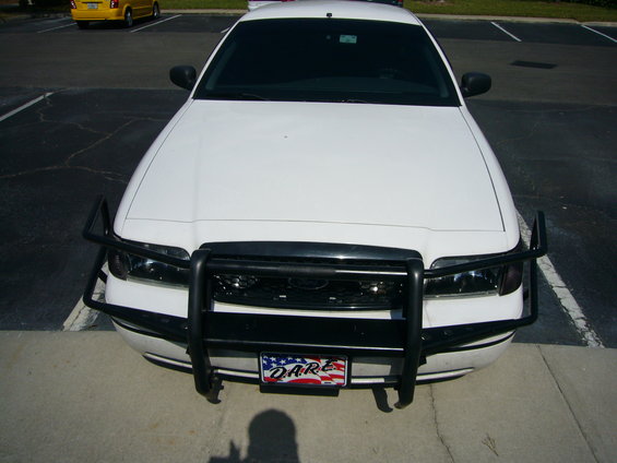 White police car front view with push bumper and DARE license plate