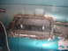 1996 Ford Bronco - Metal patch welded onto the floor of a teal vehicle, likely for rust repair.