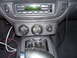 2002 Ford Crown Victoria - Aftermarket gauges installed in a car's center console, next to the radio and gear shifter.