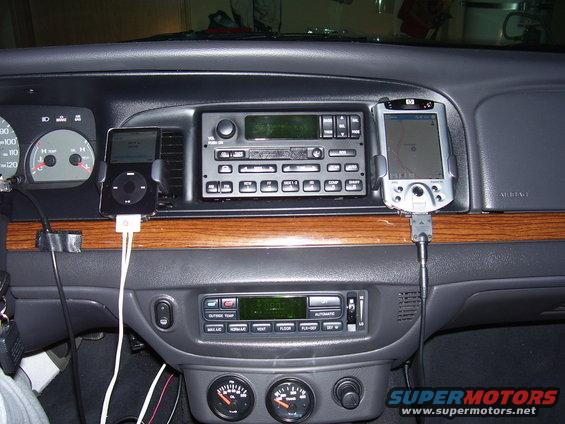 Dashboard with iPod, GPS device, and aftermarket gauges. Wood trim accents the center console