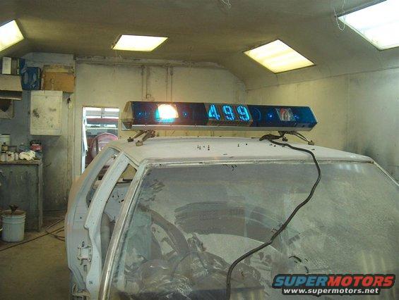 Lightbar with "499" displayed on top of a car interior