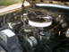 1985 Ford Crown Victoria LTD - The engine bay of a vehicle, a chrome air cleaner and various engine components.