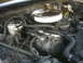 1985 Ford Crown Victoria LTD - Close-up view of an engine bay, showing the air cleaner and AC compressor.