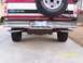 1994 Ford Bronco - The rear of a Ford Bronco shows its dual exhaust system and spare tire, with a license plate from 2004.