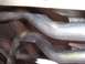 1994 Ford Bronco - The photo shows the underside of a vehicle's exhaust system with two pipes visible.