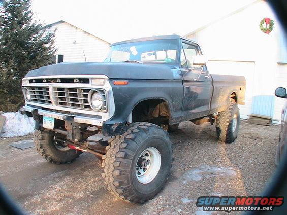 Black 1977 Ford F-250 pickup truck with large tires and lifted suspension