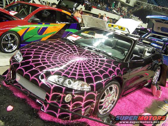 Black convertible with pink spider web graphics and chrome wheels