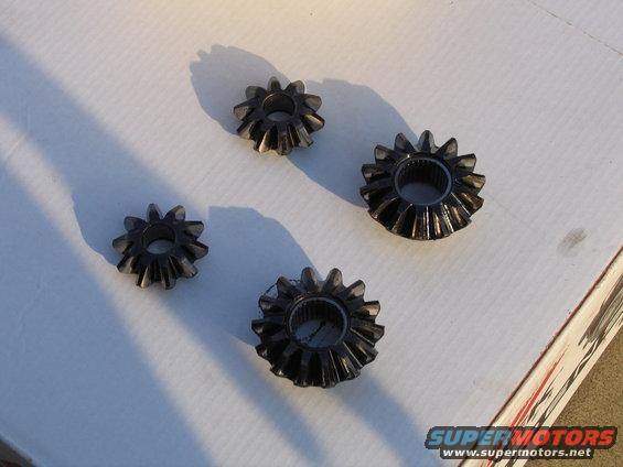 four differential gears on a white surface