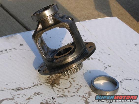 Differential carrier and bearing assembly on a white surface. SuperMotors logo visible
