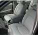 2001 Ford Crown Victoria - The light-colored cloth interior of a car, showing the front seats and dashboard area.