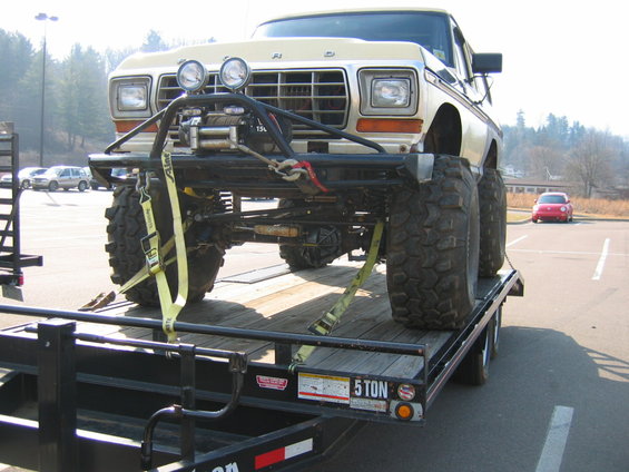 Tan Ford F-Series truck with winch on trailer, front view