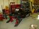 1982 Chevrolet C/K Pickup - A black Arctic Cat snowmobile is elevated on jack stands inside a cluttered garage.