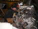 1978 Ford Bronco - Engine removal in progress, mechanic attending to the V8 motor.
