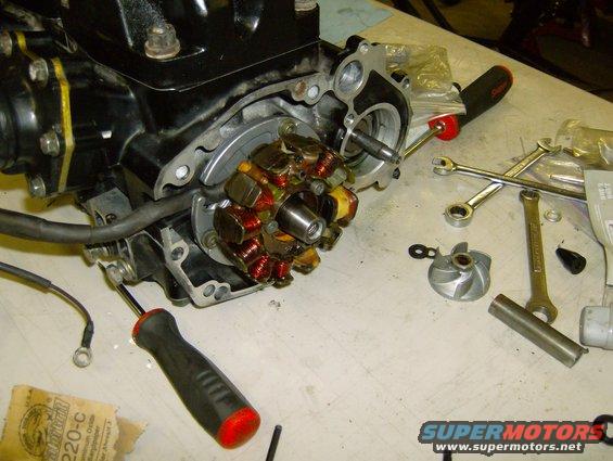 motorcycle engine with stator removed, tools on table