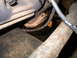 1978 Ford Bronco - Close-up view of engine bay components shows an oil leak and signs of rust.