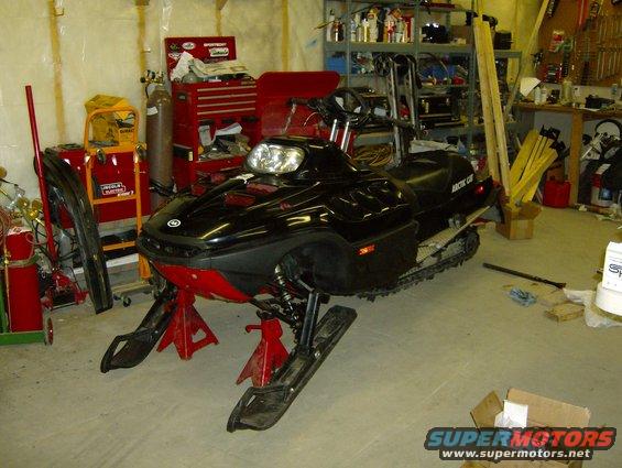Arctic Cat snowmobile on jack stands in a garage
