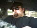 1985 Ford Crown Victoria LTD - A man with a beard and sunglasses is inside a vehicle with a distinctive leopard print headliner and door panels.