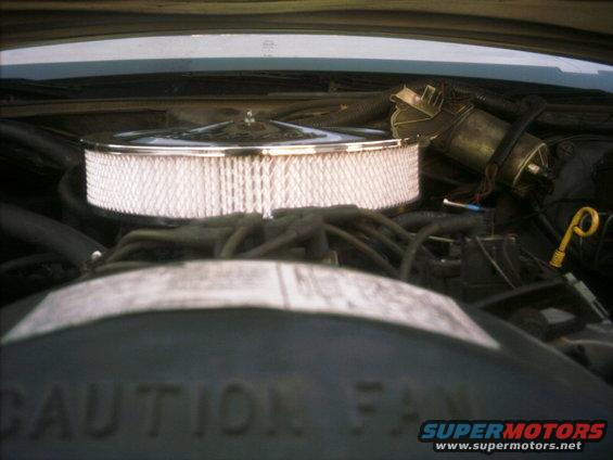 Engine bay with chrome air cleaner and visible 'CAUTION FAN' text