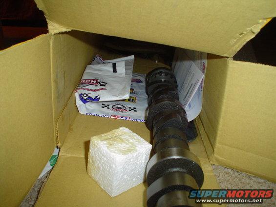 Camshaft and foam block inside a cardboard box with packaging