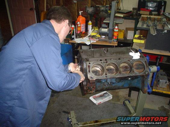 Engine block on stand with pistons visible