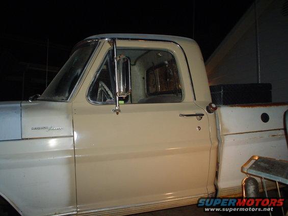 Side view of a 1967 Ford F-250 pickup truck, showing the driver's side door and bed