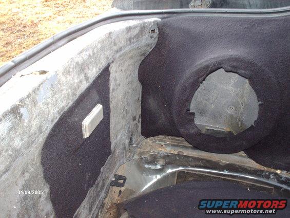 Interior of a car trunk showing carpeting and a circular cutout. Date stamp reads 01/09/2005
