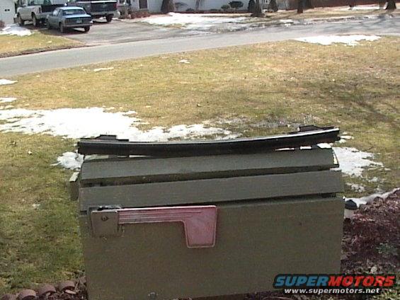 Black trim piece on green mailbox