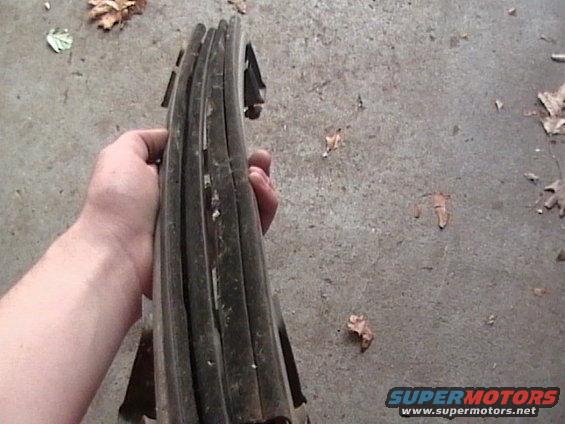 Hand holding stacked car door seals