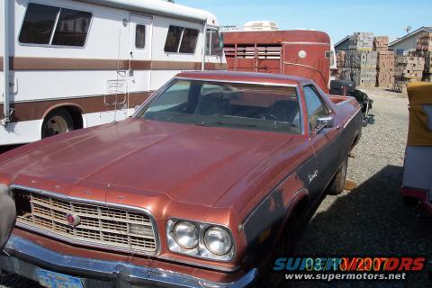 Red 1972 Ford Ranchero with black side trim, showing front grille and headlights