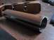 2003 Ford Crown Victoria - A close-up view of a brown metal pipe part on a wooden table.