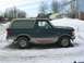 1995 Ford Bronco - A side view of a Ford Bronco in a snowy environment.