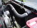 1989 Ford Bronco - Close-up view of the radiator and associated engine components, including hoses and the alternator.