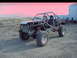 1984 Ford Bronco - A custom-built buggy sits in a dusty yard with buildings and hills in the background.